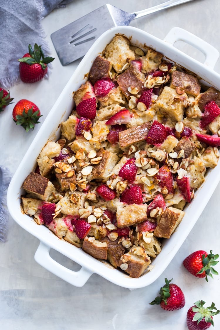 Baked French Toast (Vegan) with fresh berries orange zest and almonds. A healthy version of our favorite brunch recipe! Can be made ahead! #brunch #mothersday #veganbrunch #vegan #frenchtoast #feastingathome #healthybreakfast