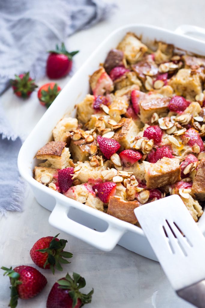 Baked French Toast (Vegan) with fresh berries orange zest and almonds. A healthy version of our favorite brunch recipe! Can be made ahead! #brunch #mothersday #veganbrunch #vegan #frenchtoast #feastingathome #healthybreakfast