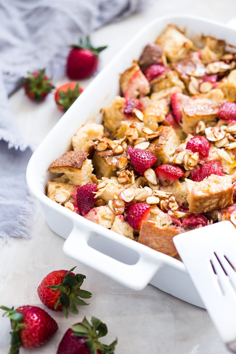 Baked French Toast (Vegan) with fresh berries orange zest and almonds. A healthy version of our favorite brunch recipe! Can be made ahead! #brunch #mothersday #veganbrunch #vegan #frenchtoast #feastingathome #healthybreakfast