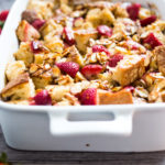 Baked French Toast (Vegan) with silken tofu, fresh berries orange zest and almonds. A healthy version of our favorite brunch recipe! Can be made ahead! #brunch #mothersday #veganbrunch #vegan #frenchtoast #feastingathome #healthybreakfast