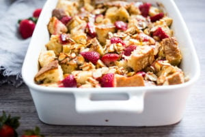Baked French Toast (Vegan) with silken tofu, fresh berries orange zest and almonds. A healthy version of our favorite brunch recipe! Can be made ahead! #brunch #mothersday #veganbrunch #vegan #frenchtoast #feastingathome #healthybreakfast