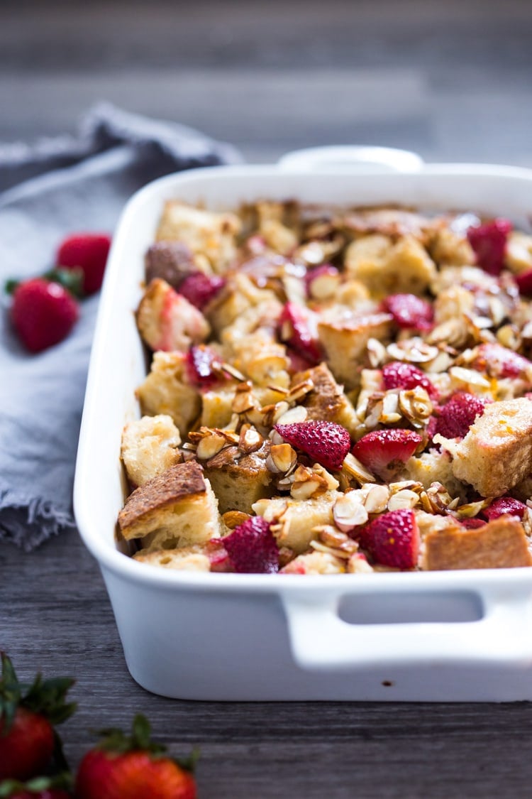 Baked French Toast (Vegan) with silken tofu, fresh berries orange zest and almonds. A healthy version of our favorite brunch recipe! Can be made ahead! #brunch #mothersday #veganbrunch #vegan #frenchtoast #feastingathome #healthybreakfast