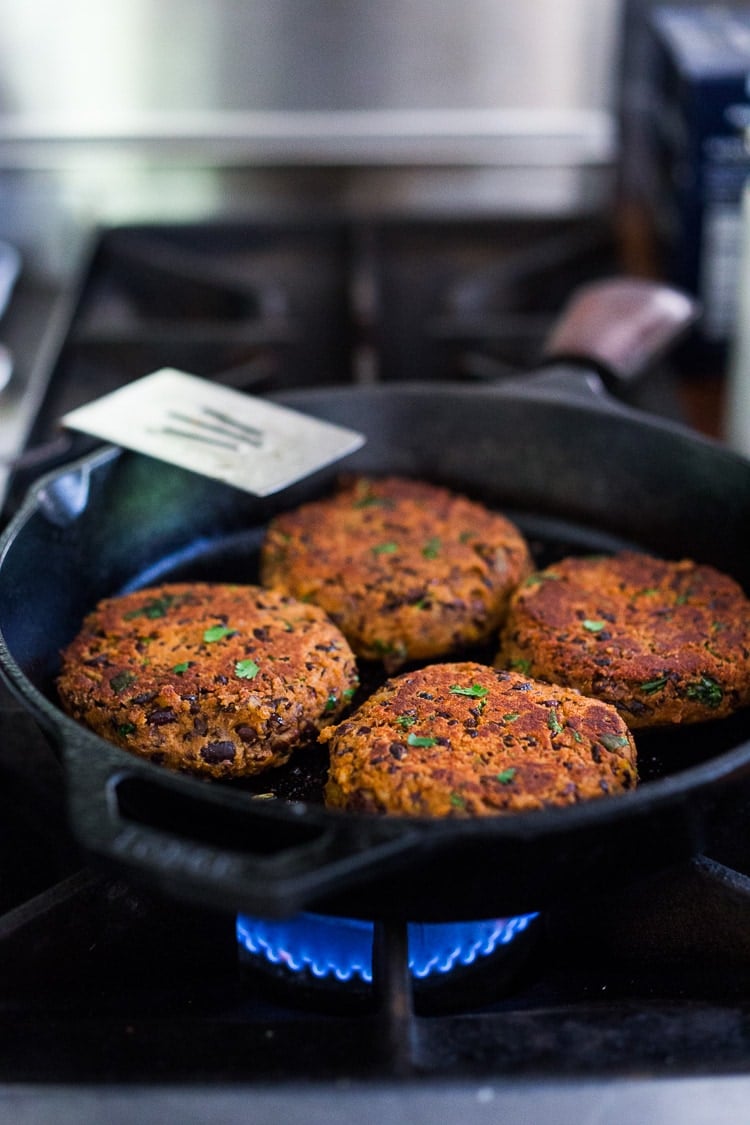 searing the black bean burgers in a skillet.