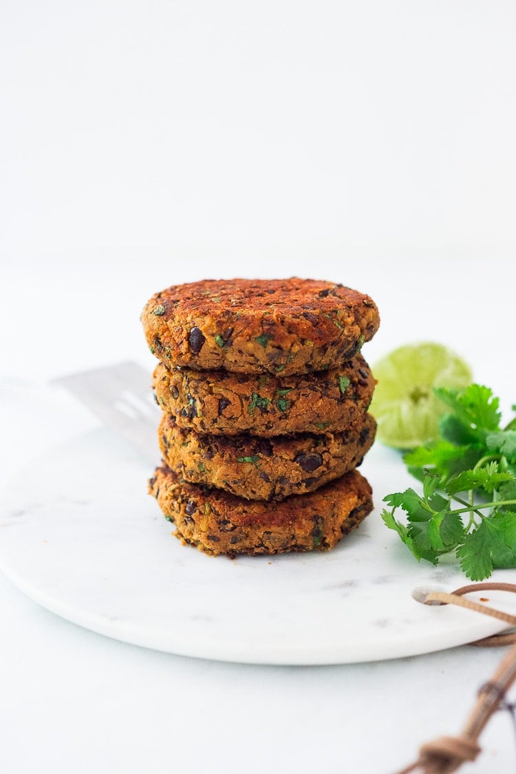 black bean burgers stacked on a plate. 