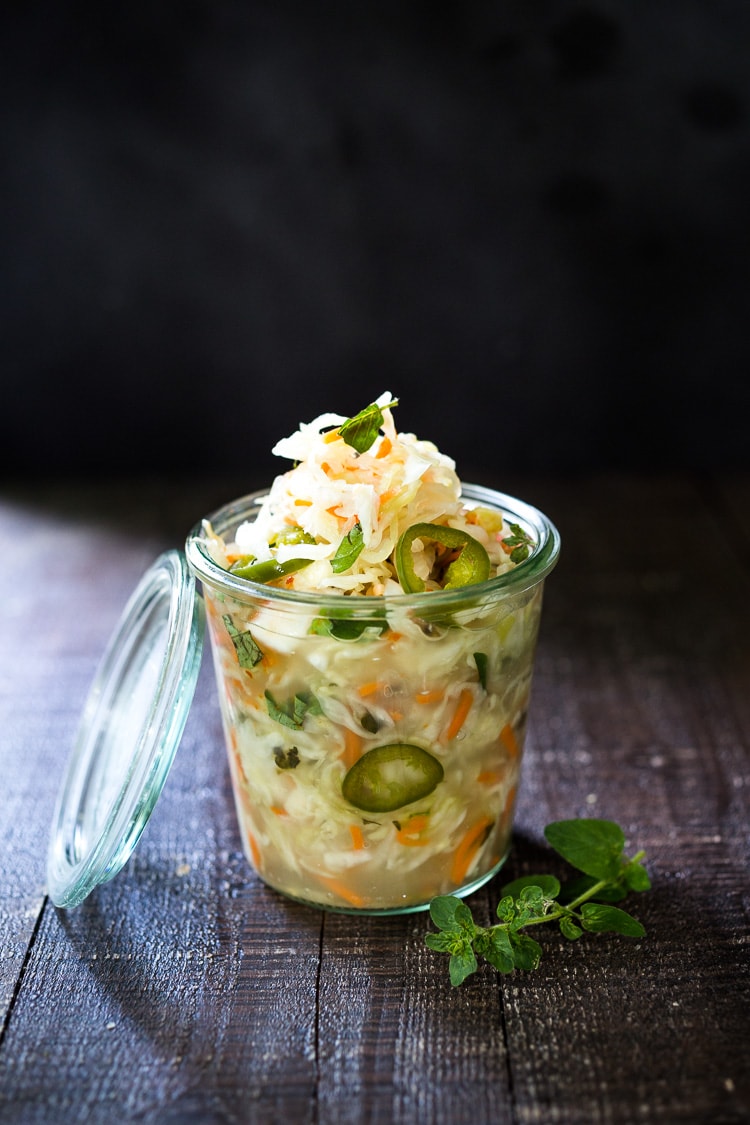 Curtido - A cultured Salvadorian Slaw with cabbage, carrots, onion and oregano. Simple to make, full of healthy probiotics! Use on Tacos, Pupusas, quesadillas or enchiladas as a delicious healthy condiment! #Curtido #fermented #slaw #cultured #kraut 