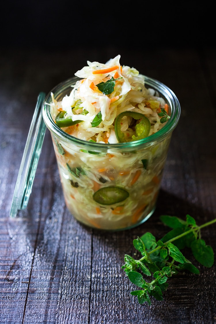 Curtido - A fermented Salvadorian Slaw ( or Kraut) made with cabbage, carrots, onion and oregano. Simple to make, full of healthy probiotics! Use on Tacos, Pupusas, quesadillas or enchiladas as a delicious healthy condiment! #Curtido #fermented #slaw #cultured #kraut