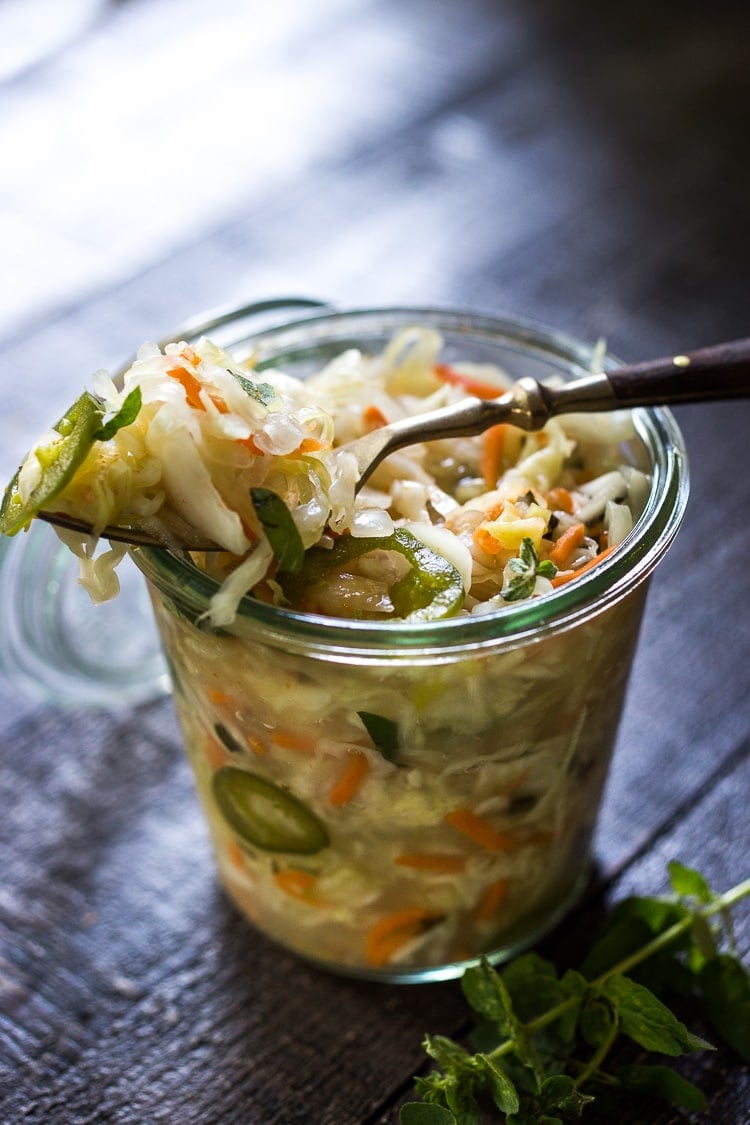 Curtido - A cultured Salvadorian Slaw with cabbage, carrots, onion and oregano. Simple to make, full of healthy probiotics! Use on Tacos, Pupusas, quesadillas or enchiladas as a delicious healthy condiment! #Curtido #fermented #slaw #cultured #kraut