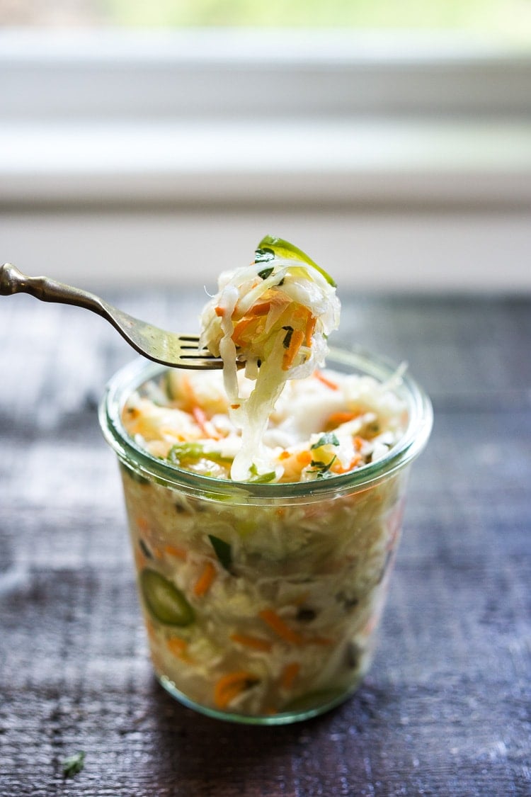 Curtido - A cultured Salvadorian Slaw with cabbage, carrots, onion and oregano. Simple to make, full of healthy probiotics! Use on Tacos, Pupusas, quesadillas or enchiladas as a delicious healthy condiment! #Curtido #fermented #slaw #cultured #kraut