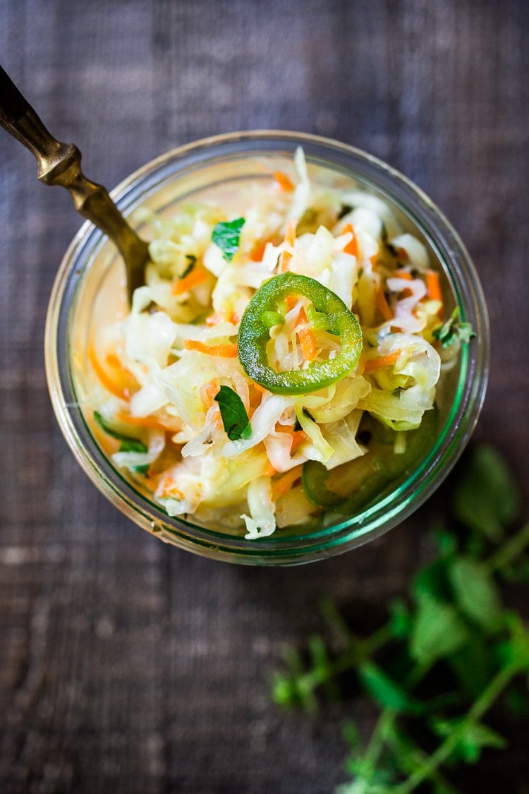 Curtido - A cultured Salvadorian Slaw with cabbage, carrots, onion and oregano. Simple to make, full of healthy probiotics! Use on Tacos, Pupusas, quesadillas or enchiladas as a delicious healthy condiment! #Curtido #fermented #slaw #cultured #kraut