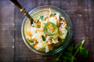 Curtido - A cultured Salvadorian Slaw with cabbage, carrots, onion and oregano. Simple to make, full of healthy probiotics! Use on Tacos, Pupusas, quesadillas or enchiladas as a delicious healthy condiment! #Curtido #fermented #slaw #cultured #kraut