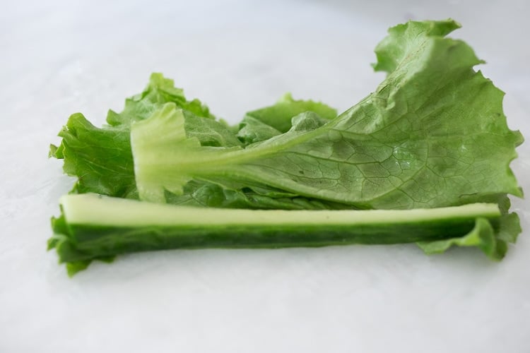 laying lettuce in center of rice paper wrapper.