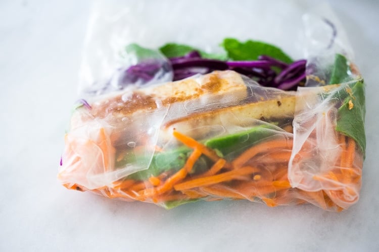 partially folded spring roll with one end folded in and the sides tucked in.