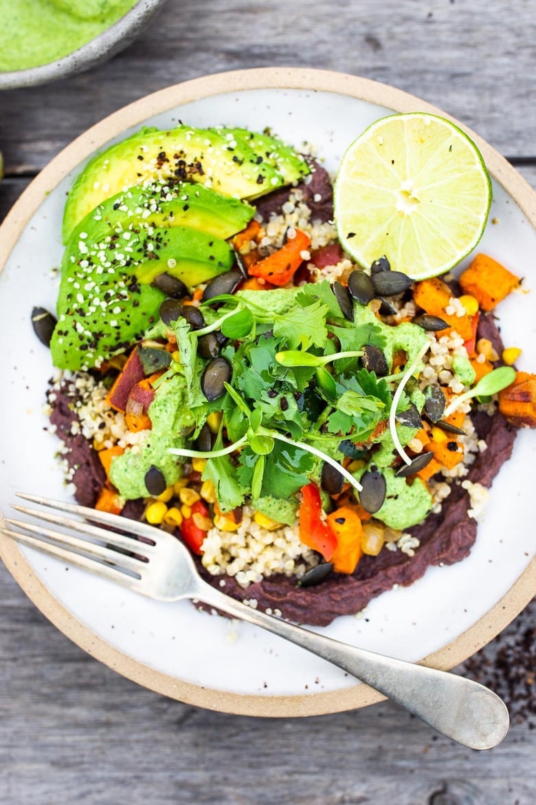 Vegan Peruvian Burrito Bowls, filled with roasted sweet potato, fresh corn, peppers, quinoa and creamy blackbeans, then drizzled with spicy Peruvian Green Sauce. A flavor bomb! Vegan and Delicious! #vegan #burrito #peruvianfood #peruvianrecipes #veganburrito 