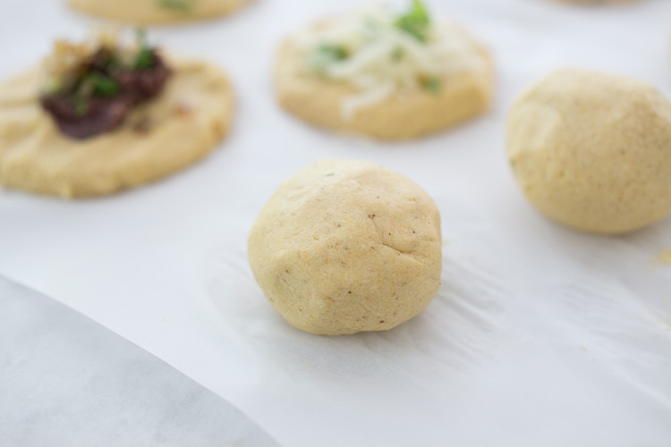 How to make Pupusas!  Delicious Salvadorian masa corn cakes filled with your choice of refried beans or cheese (or both!) with cilantro and scallions. A simple, easy recipe that is Vegan adaptable! #pupusa #pupusas #pupusarecipe #curtido #corncakes #masa #masacakes