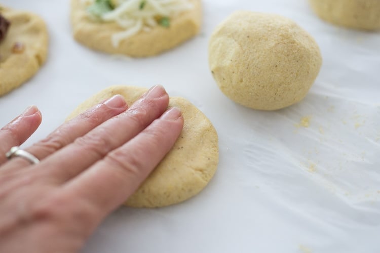 How to make Pupusas!  Delicious Salvadorian masa corn cakes filled with your choice of refried beans or cheese (or both!) with cilantro and scallions. A simple, easy recipe that is Vegan adaptable! #pupusa #pupusas #pupusarecipe #curtido #corncakes #masa #masacakes