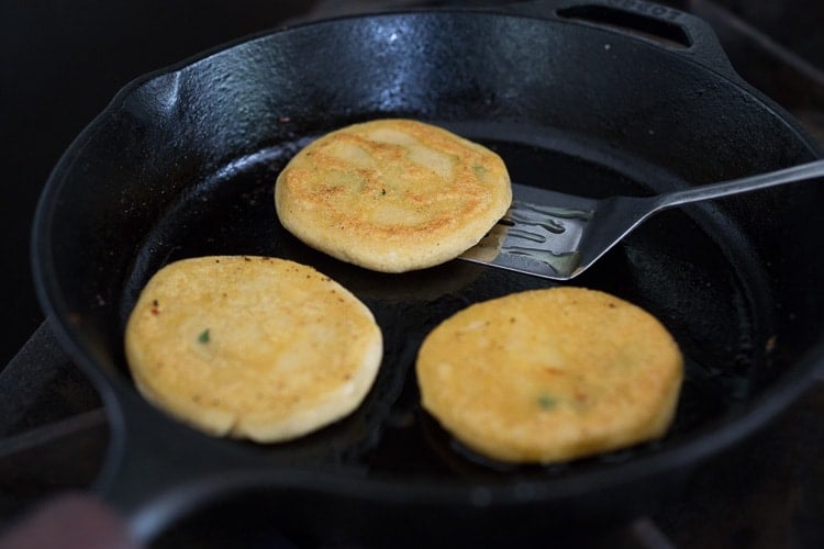 How to make Pupusas!  Delicious Salvadorian masa corn cakes filled with your choice of refried beans or cheese (or both!) with cilantro and scallions. A simple, easy recipe that is Vegan adaptable! #pupusa #pupusas #pupusarecipe #curtido #corncakes #masa #masacakes
