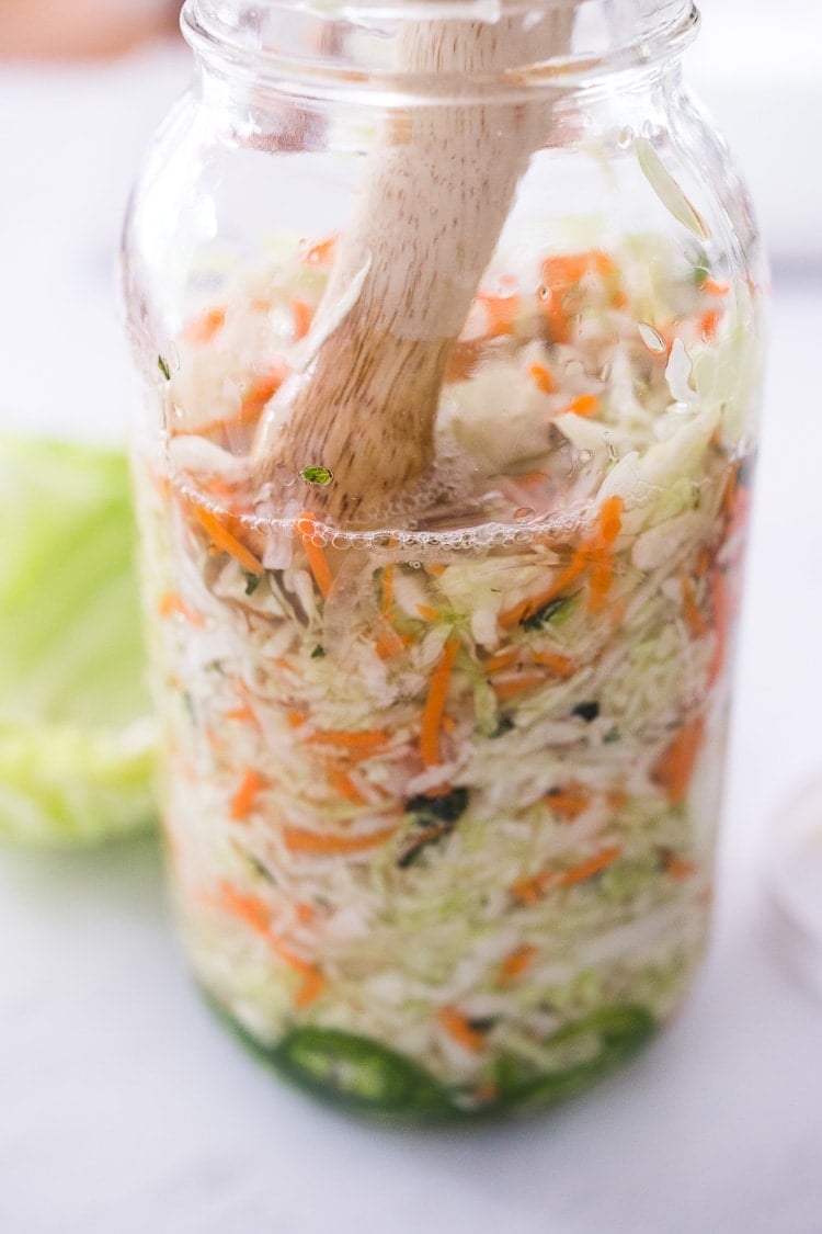 Curtido - A cultured Salvadorian Slaw with cabbage, carrots, onion and oregano. Simple to make, full of healthy probiotics! Use on Tacos, Pupusas, quesadillas or enchiladas as a delicious healthy condiment! #Curtido #fermented #slaw #cultured #kraut