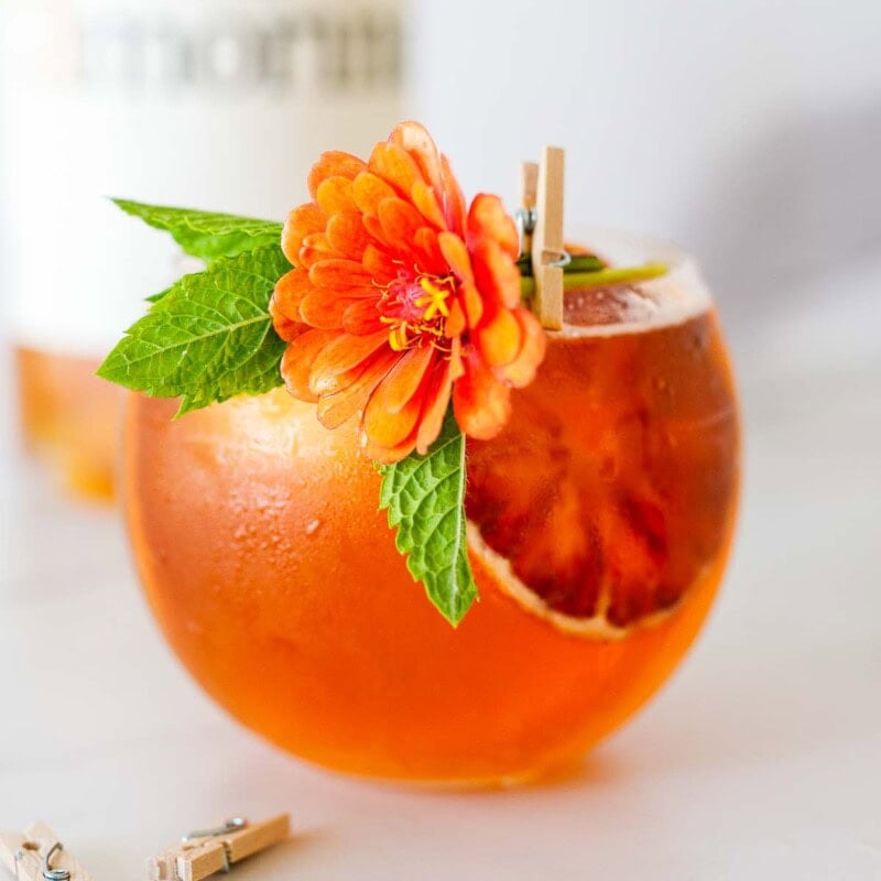 Elevated Aperol Spritz made with Amaro, in a glass with ice.