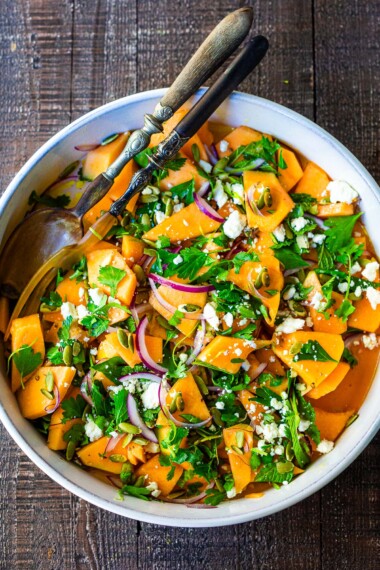 A refreshing Cantaloupe Salad with mint, lime, and pepitas with optional crumbled feta cheese- a tasty, healthy summer salad, perfect for potlucks and gatherings.