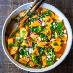 A refreshing Cantaloupe Salad with mint, lime, and pepitas with optional crumbled feta cheese- a tasty, healthy summer salad, perfect for potlucks and gatherings.