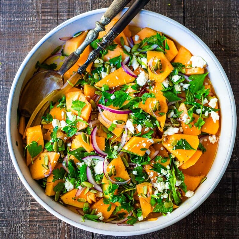 A refreshing Cantaloupe Salad with mint, lime, and pepitas with optional crumbled feta cheese- a tasty, healthy summer salad, perfect for potlucks and gatherings.