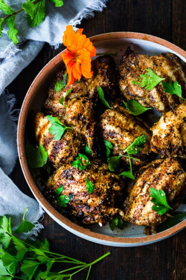 Grilled Moroccan Chicken with Ras El Hanout, garlic and lemon - a simple healthy recipe, using skinless chicken thighs, bursting with North African flavor! Delicious, fast and easy! #moroccanchicken #raselhanout #moroccanfood #moroccan