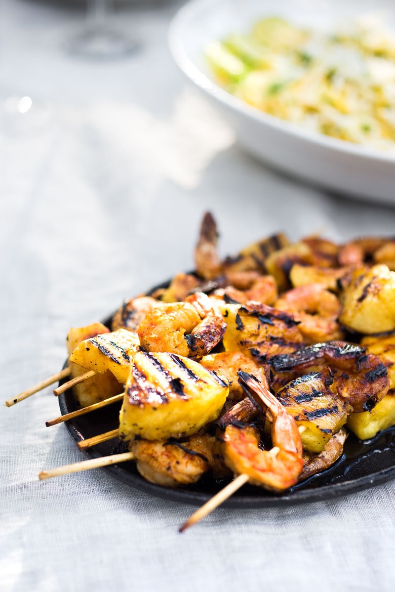 Grilled Shrimp Skewers with Pineapple in a flavorful Chipotle Marinade served with a refreshing Jicama Mango Slaw with cilantro and lime. Healthy and Easy! #grilledshrimp #shrimpskewers #shrimpkabobs #skewers www.feastingathome.com