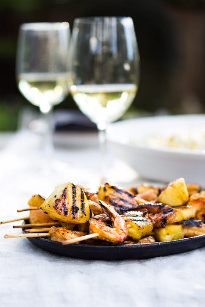 Grilled Shrimp Skewers with Pineapple in a flavorful Chipotle Marinade served with a refreshing Jicama Mango Slaw with cilantro and lime. Healthy and Easy! #grilledshrimp #shrimpskewers #shrimpkabobs #skewers www.feastingathome.com