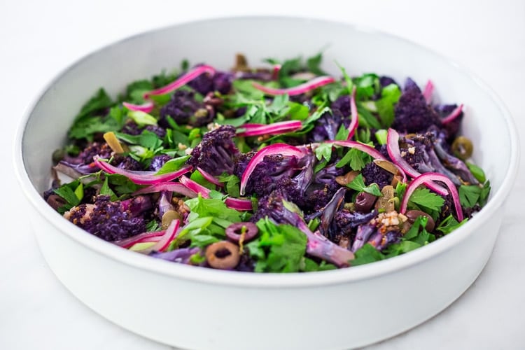 Purple Cauliflower Salad (Sicilian Style!) with olives, grains, capers, parlsely scallions and pickled onions. This vegan healthy salad is easy to make and keeps for several days, perfect for meal prep! | #cauliflowersalad #vegansalad #roastedcauliflowersalad #purplecauliflower 