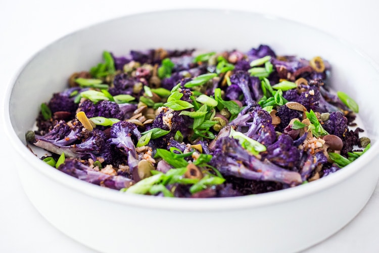 Purple Cauliflower Salad (Sicilian Style!) with olives, grains, capers, parlsely scallions and pickled onions. This vegan healthy salad is easy to make and keeps for several days, perfect for meal prep! | #cauliflowersalad #vegansalad #roastedcauliflowersalad #purplecauliflower 