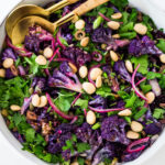 Purple Cauliflower Salad (Sicilian Style!) with olives, grains, capers, parlsely scallions and pickled onions. This vegan healthy salad is easy to make and keeps for several days, perfect for meal prep! | #cauliflowersalad #vegansalad #roastedcauliflowersalad #purplecauliflower