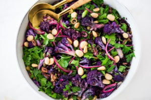 Purple Cauliflower Salad (Sicilian Style!) with olives, grains, capers, parlsely scallions and pickled onions. This vegan healthy salad is easy to make and keeps for several days, perfect for meal prep! | #cauliflowersalad #vegansalad #roastedcauliflowersalad #purplecauliflower