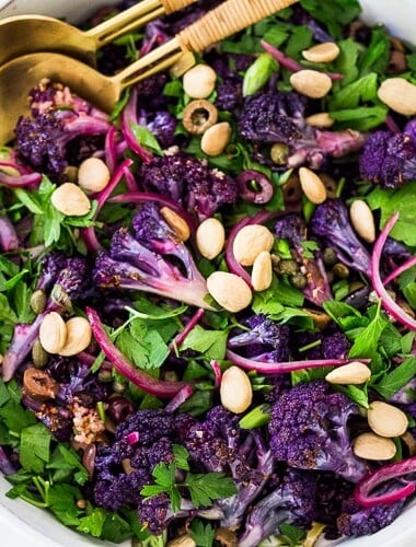 Purple Cauliflower Salad (Sicilian Style!) with olives, grains, capers, parlsely scallions and pickled onions. This vegan healthy salad is easy to make and keeps for several days, perfect for meal prep! | #cauliflowersalad #vegansalad #roastedcauliflowersalad #purplecauliflower