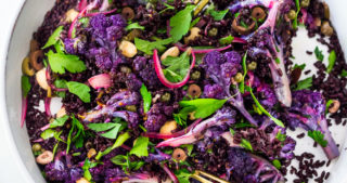 Purple Cauliflower Salad (Sicilian Style!) with olives, grains, capers, parlsely scallions and pickled onions. This vegan healthy salad is easy to make and keeps for several days, perfect for meal prep! | #cauliflowersalad #vegansalad #roastedcauliflowersalad #purplecauliflower