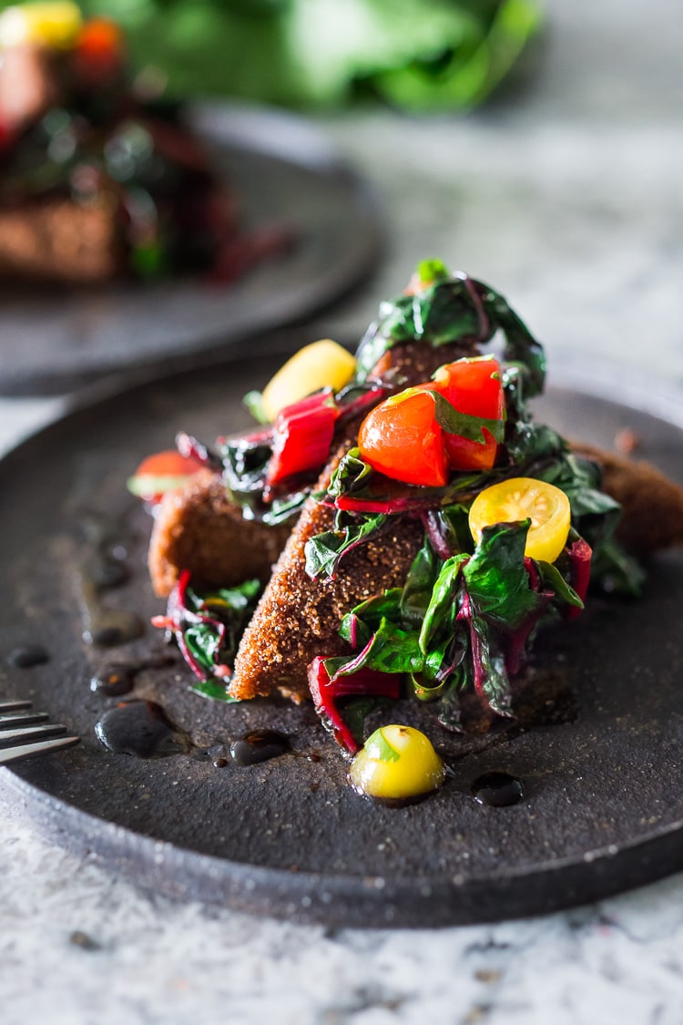 Savory Teff Cakes with Wilted Chard and fresh Tomato Relish - a simple delicious vegan meal that is full of protein and nutrients! #teff #teffrecipes #teffcakes 