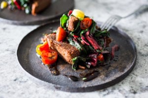 Crispy Teff Cakes with Wilted Chard and fresh Tomato Relish - a simple delicious vegan meal that is full of protein and nutrients! #teff #teffrecipes #teffcakes