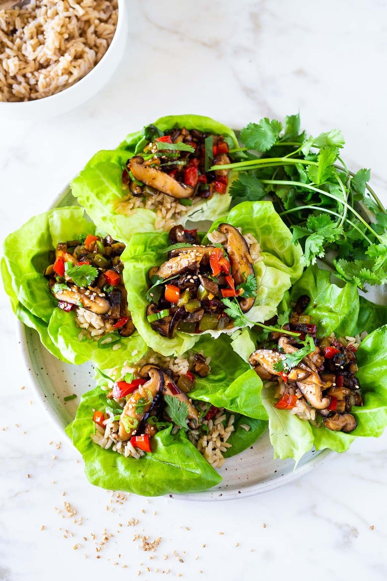 These Vegan Lettuce Wraps are filled with Teriyaki Mushrooms and brown rice- a healthy delicious lunch or appetizer! #veganlunch #vegan #veganlettucewrap #shiitakewrap