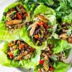 Delicious Vegan Lettuce Wraps are filled with Teriyaki Mushrooms and brown rice- an easy Asian-inspired lunch idea or appetizer that is healthy and satisfying.  #veganlunch #vegan #veganlettucewrap #shiitakewrap
