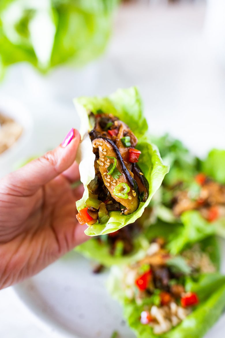 Delicious Vegan Lettuce Wraps are filled with Teriyaki Mushrooms and brown rice- an easy Asian-inspired lunch idea or appetizer that is healthy and satisfying.  #veganlunch #vegan #veganlettucewrap #shiitakewrap