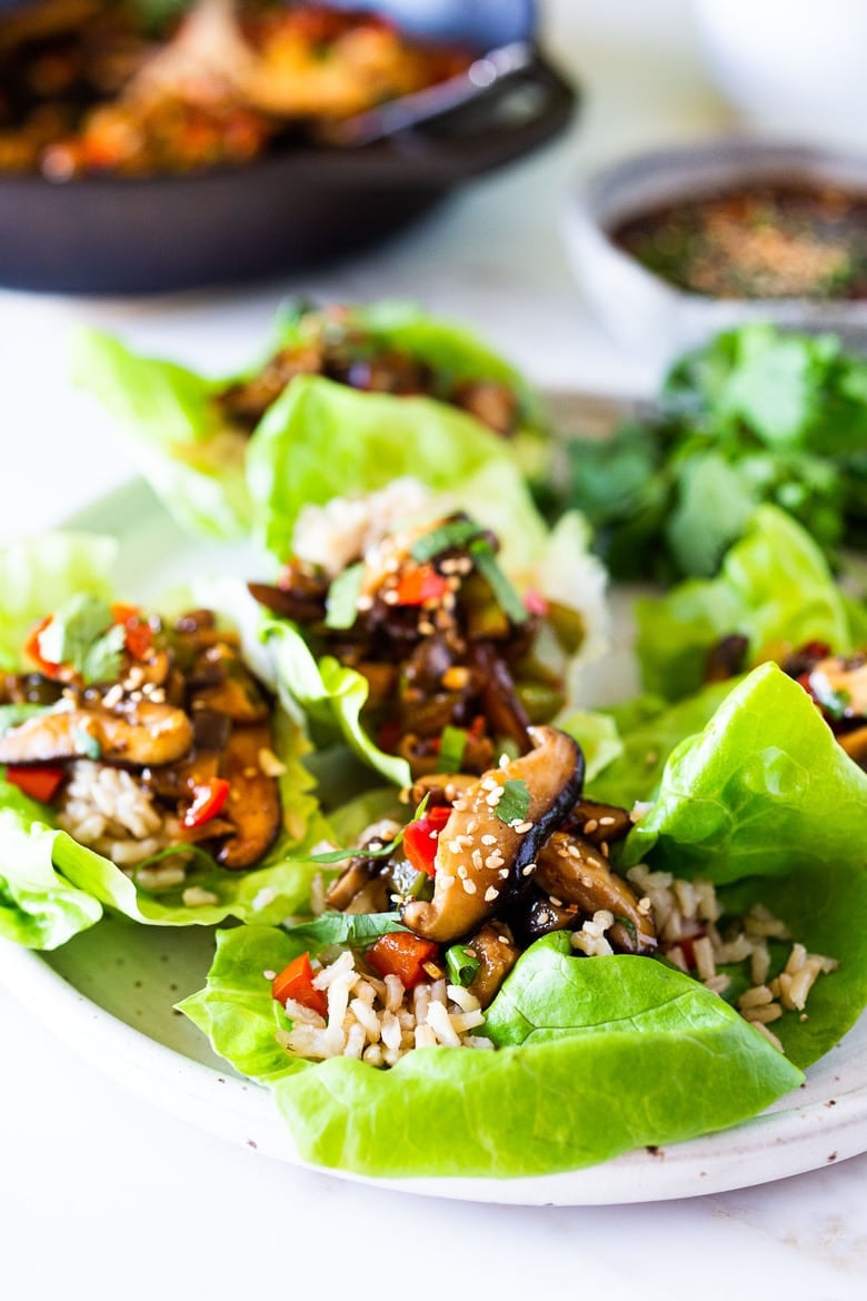 Delicious Vegan Lettuce Wraps are filled with Teriyaki Mushrooms and brown rice- an easy Asian-inspired lunch idea or appetizer that is healthy and satisfying.  #veganlunch #vegan #veganlettucewrap #shiitakewrap