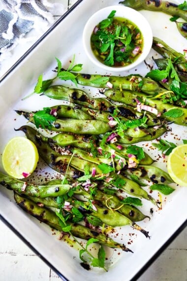Grilled Fava Beans- with Mint, Lemon & Sumac, a simple, easy way to prepare fresh fava beans on the grill with Middle Eastern flavors. #fava #favabeans #grilled #favabeanrecipes