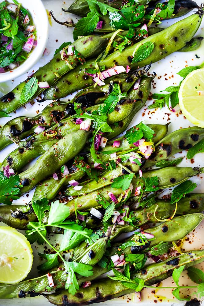 Grilled Fava Beans- with Mint, Lemon & Sumac, a simple, easy way to prepare fresh fava beans on the grill with Middle Eastern flavors. #fava #favabeans #grilled #favabeanrecipes