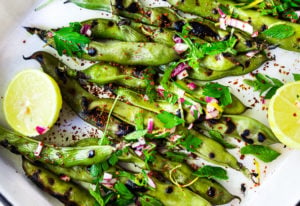 Grilled Fava Beans- with Mint, Lemon & Sumac, a simple, easy way to prepare fresh fava beans on the grill with Middle Eastern flavors. #fava #favabeans #grilled #favabeanrecipes