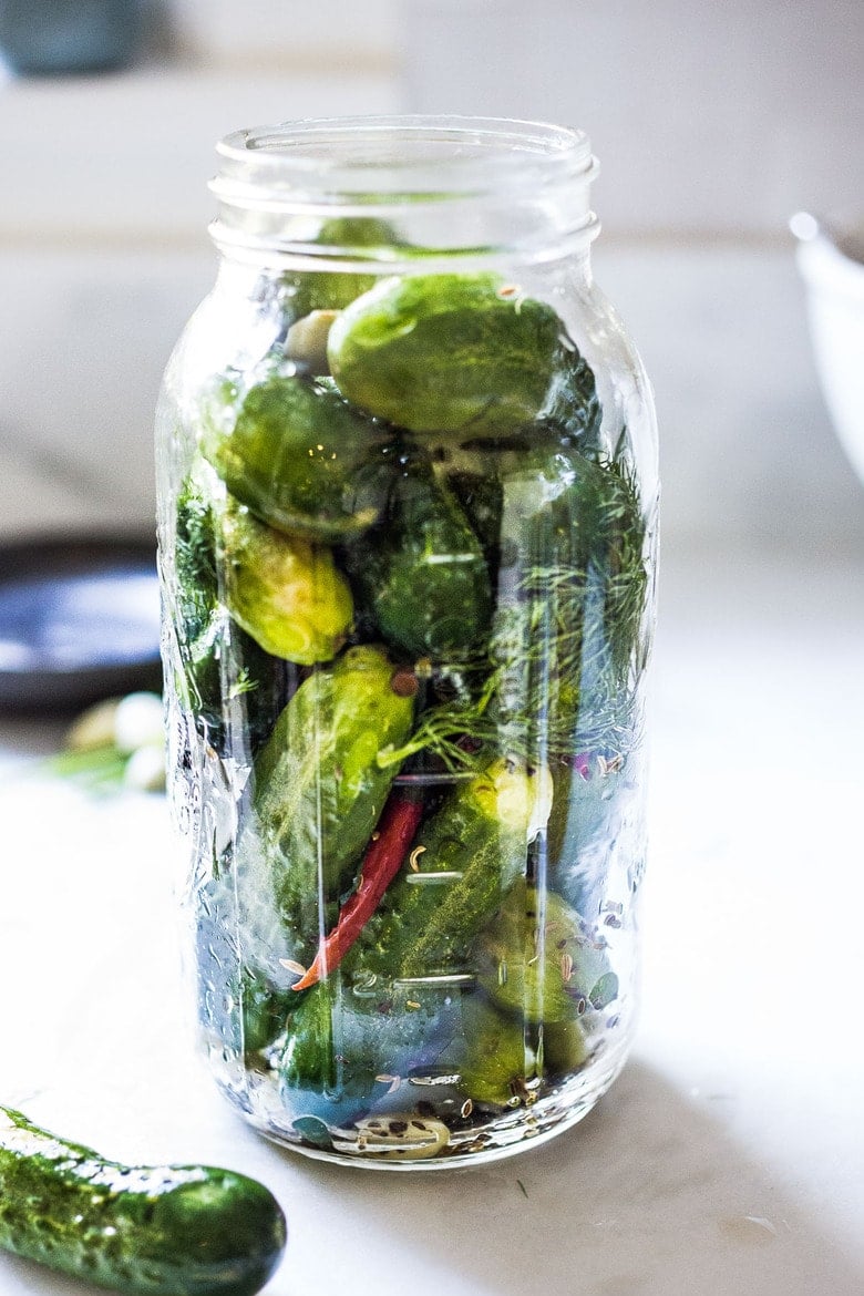 layering the cucumbers in the jar. 