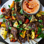 Grilled Lamb Chops with Harissa Yogurt and summer veggies- a simple easy meal, perfect for entertaining! #lamb #lambchops #grilledlamb #grilledlambchops