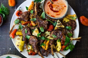 Grilled Lamb Chops with Harissa Yogurt and summer veggies- a simple easy meal, perfect for entertaining! #lamb #lambchops #grilledlamb #grilledlambchops