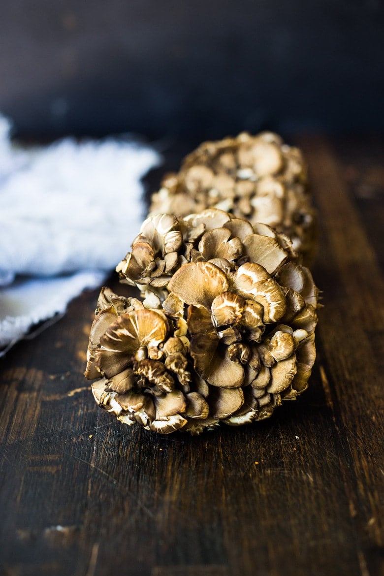 maitake mushrooms on wood table.