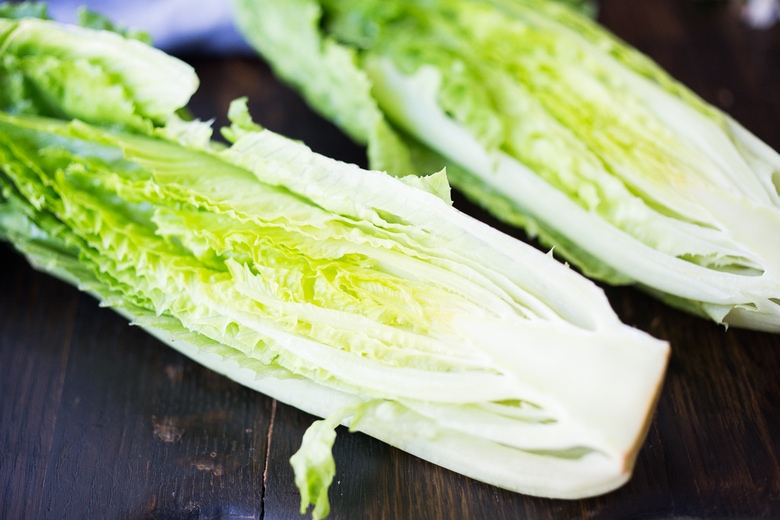romaine lettuce head sliced into two halves lengthwise.