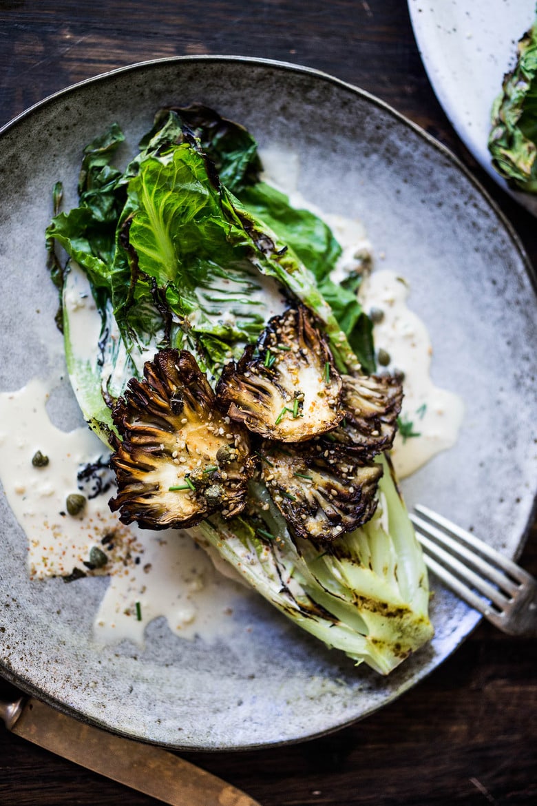 grilled romaine salad grilled romaine salad with maitake mushrooms served with caesar dressing, capers, and furikake.