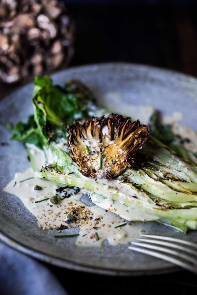 grilled romaine salad grilled romaine salad with maitake mushrooms, caesar dressing, capers, furikake, chives.